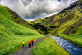 Scenery front of Kvernufoss waterfall with group of tourist and