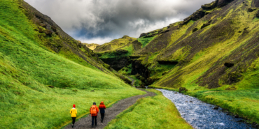 Scenery front of Kvernufoss waterfall with group of tourist and