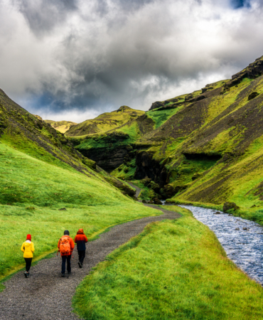 Scenery front of Kvernufoss waterfall with group of tourist and