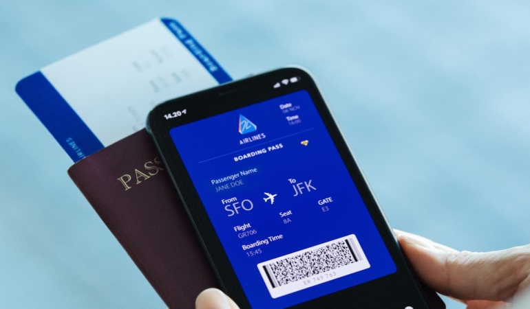 Traveler-at-airport-using-digital-boarding-pass-phone-app-stock-photo-1414x707